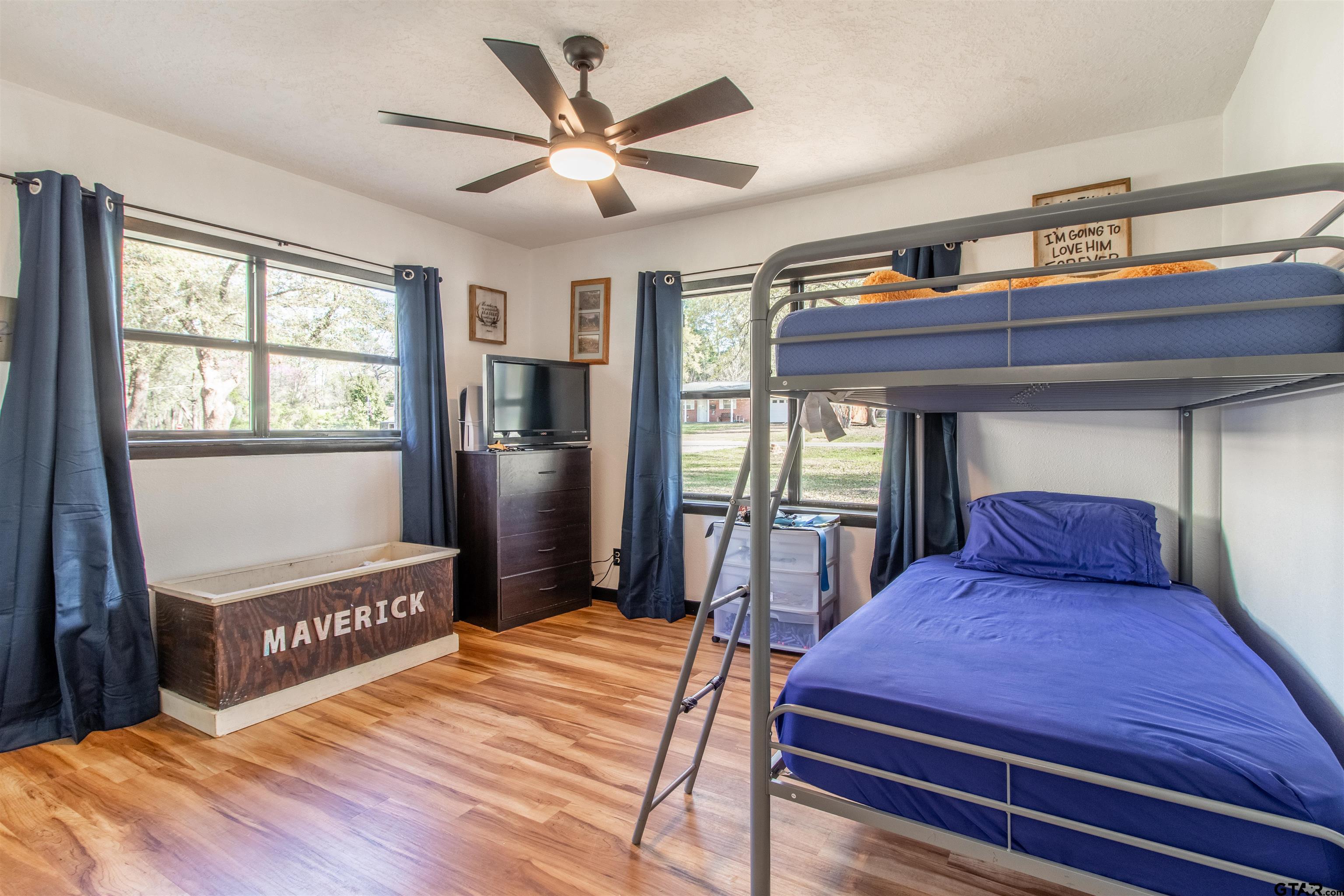 513 Lance Road Quitman, TX 75783 - Photo 11 of 27 a bedroom with a large bed and a chandelier