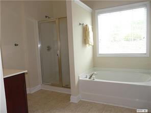 13617 Porter Creek Road Charlotte, NC 28262 - Photo 8 of 11 a bathroom with a bathtub and a shower