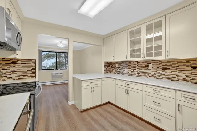 a kitchen with granite countertop a refrigerator and a stove