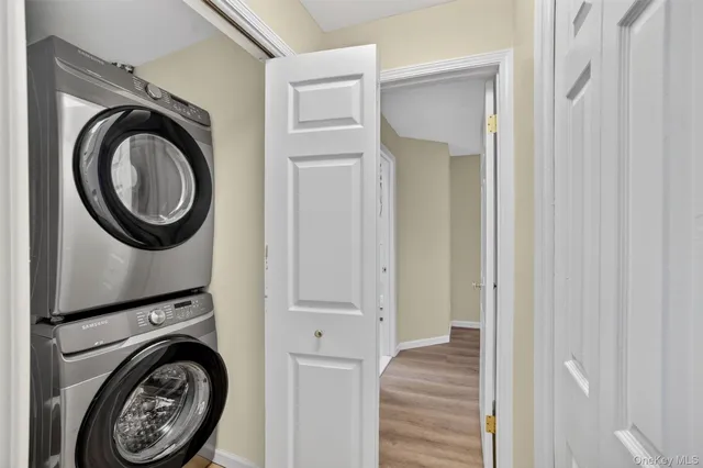 a bathroom with a toilet a sink a mirror and shower