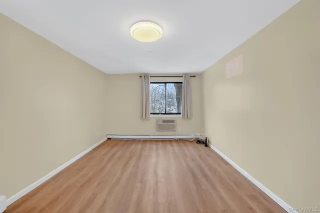 a bedroom with a large bed and a potted plant