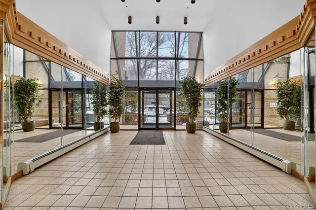 a lobby with furniture and large windows