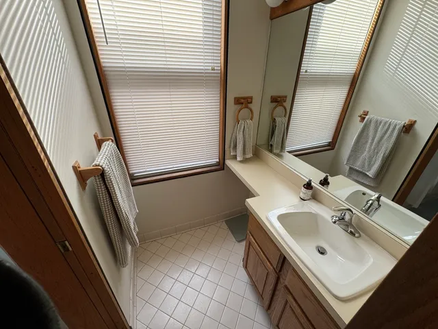 a kitchen with stainless steel appliances a stove a sink a microwave a refrigerator and cabinets