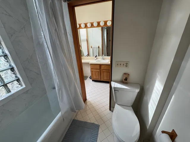 a kitchen with granite countertop a sink cabinets and wooden floor