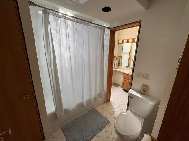 a view of a workspace with furniture and wooden floor