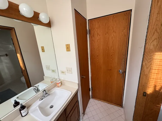 a view of a balcony with two chairs and a barbeque