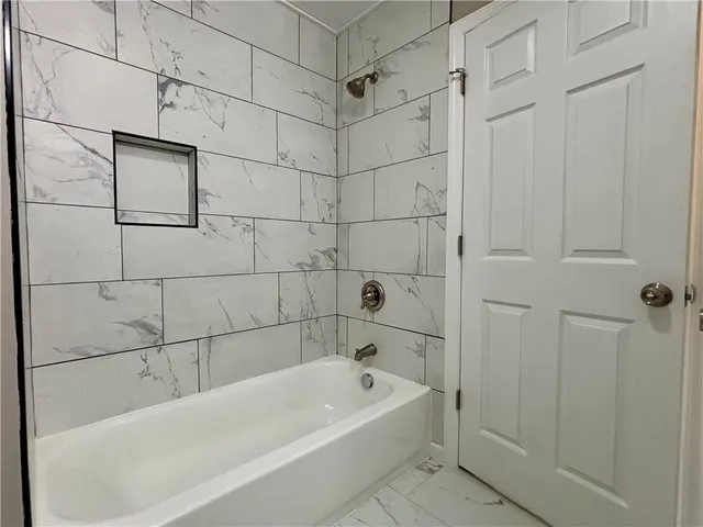 a view of a room with wooden floor and windows