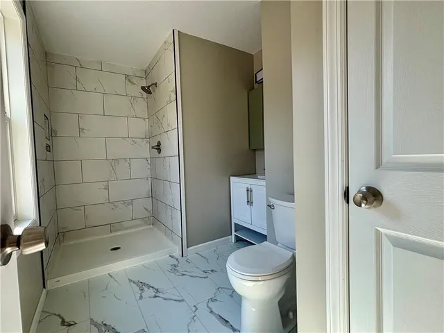 a bathroom with a bathtub and a shower
