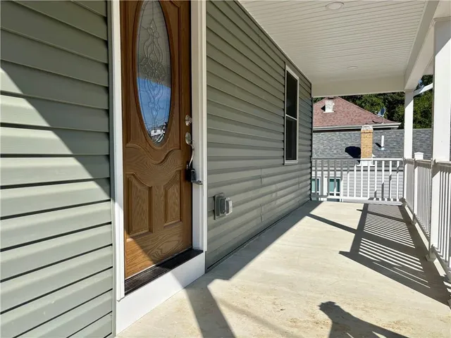 a view of a balcony with wooden floor and fence