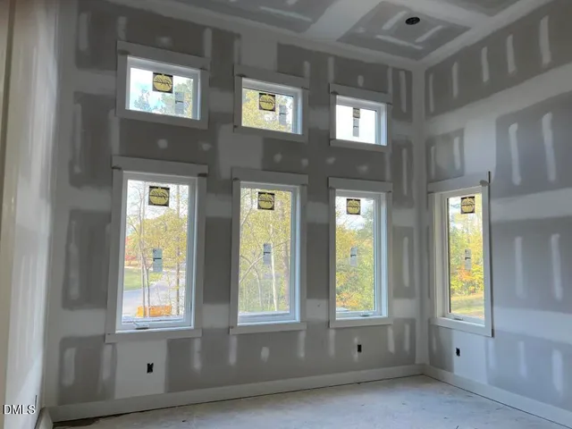 a view of a bathroom with granite countertop a mirror and a bathtub