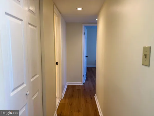 a view of a hallway with wooden floor