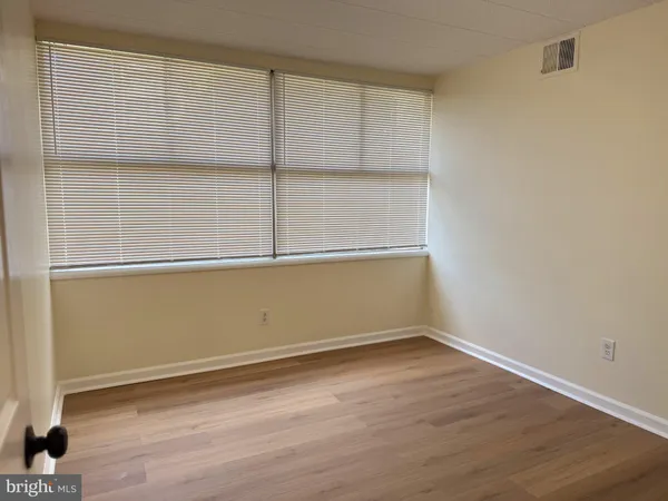 an empty room with wooden floor