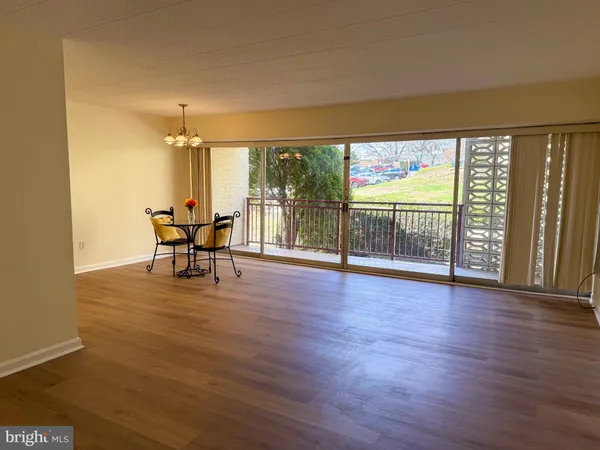 a view of a livingroom with furniture wooden floor and window