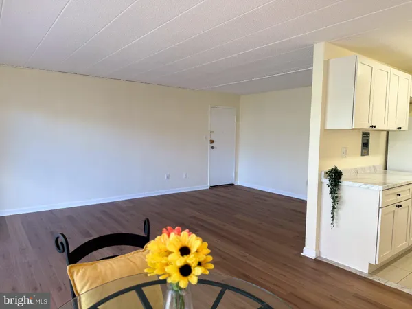 a view of a bedroom with wooden floor and a window