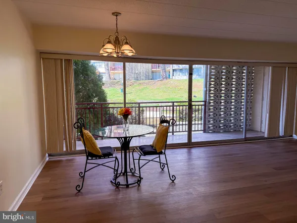 a dining room with furniture window and wooden floor