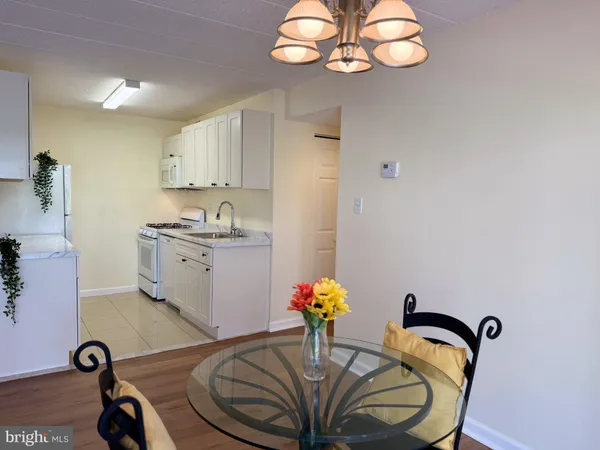 a kitchen with a table and a chandelier