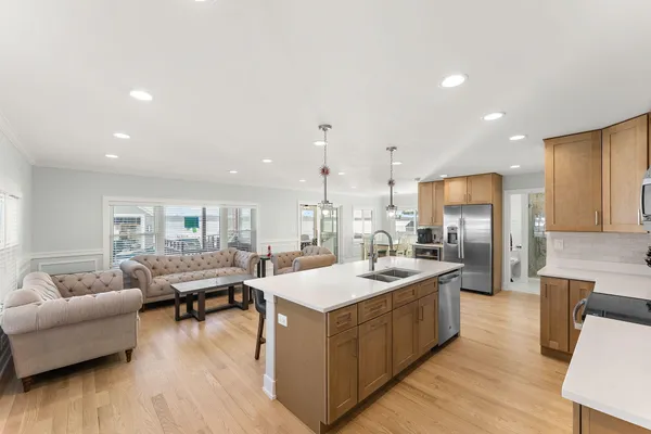 a large kitchen with a large counter top appliances and cabinets
