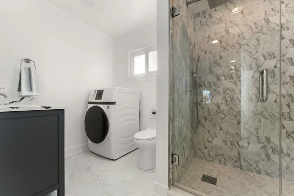 a bathroom with a toilet and a shower