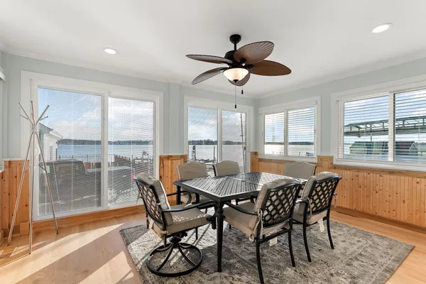 a dining room with furniture a chandelier and wooden floor