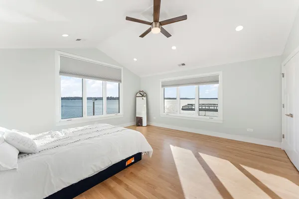 a bedroom with a large bed and a window