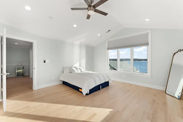 a spacious bedroom with a large bed and a large window