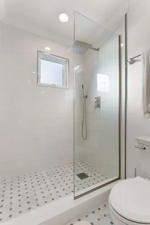 a bathroom with a shower a toilet and a sink