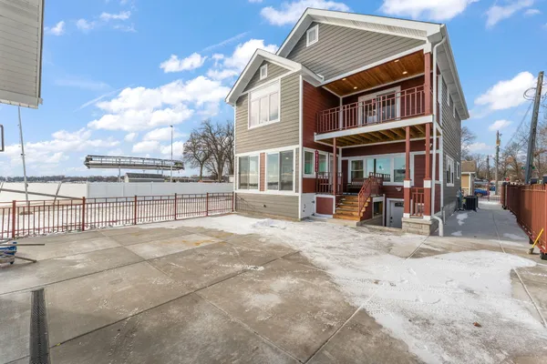 a view of a house with wooden fence
