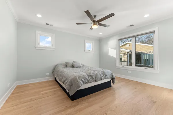 a spacious bedroom with a large bed and a window