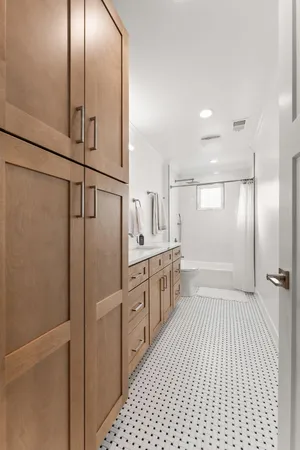 a bathroom with a shower and a double vanity sink