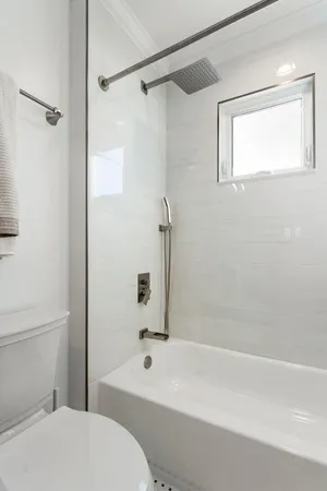 a bathroom with a bathtub and a shower