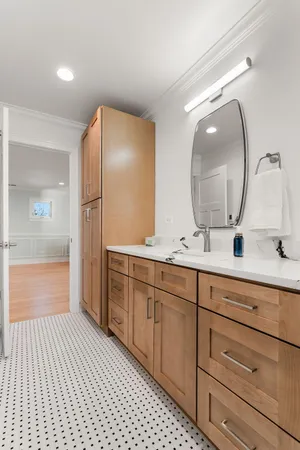 a spacious bathroom with a double vanity sink mirror and shower