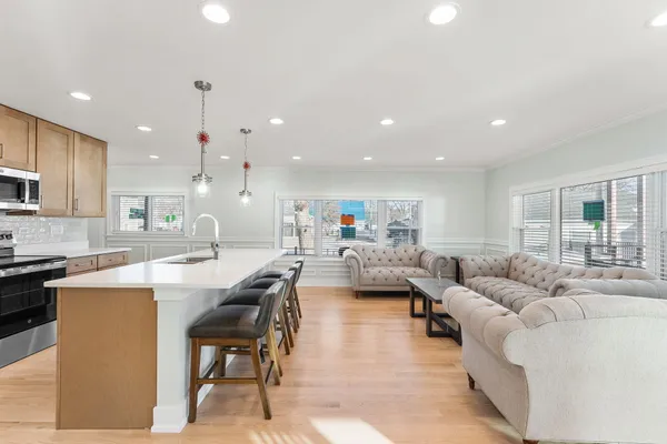 a living room with kitchen island furniture and a wooden floor