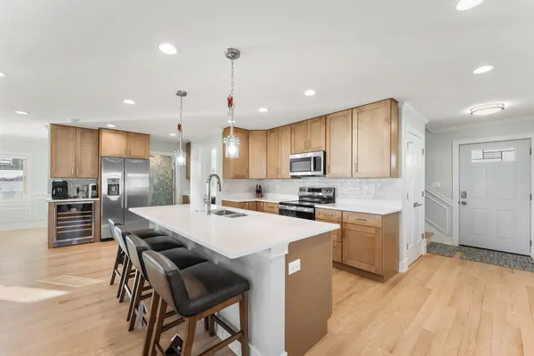 a large kitchen with lots of counter space a sink and appliances