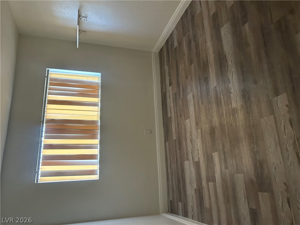 1852 North Decatur Boulevard, Unit 103 Las Vegas, NV 89108 - Photo 9 of 10 Natural light illuminates wide plank flooring in this cozy, versatile space.