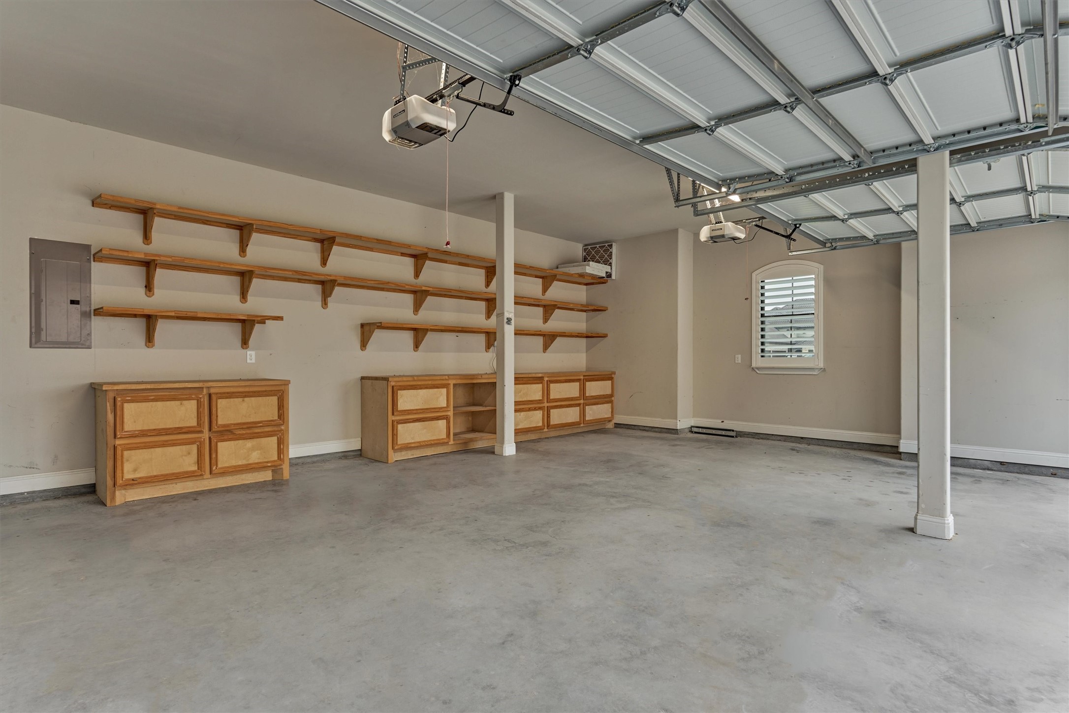 11618 Renaissance Drive Montgomery, TX 77356 - Photo 35 of 49 This clean, three-car garage offers built-in cabinets and shelving, providing abundant and well-organized storage space. The tankless water heater is also in the garage.