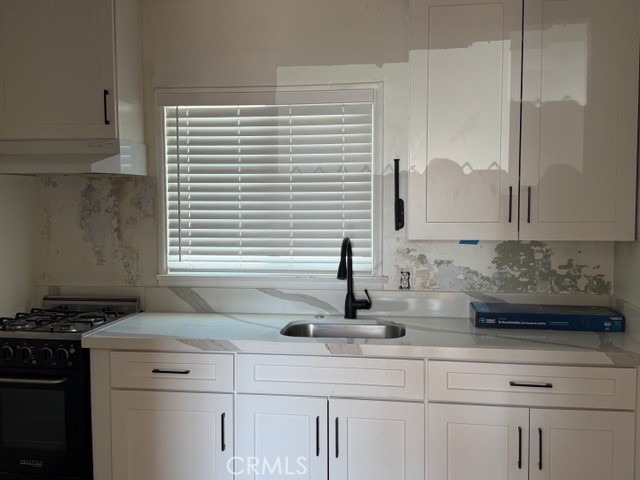 504 S Harbor Fullerton, CA 92832 - Photo 11 of 18 a kitchen with stainless steel appliances white cabinets and a window