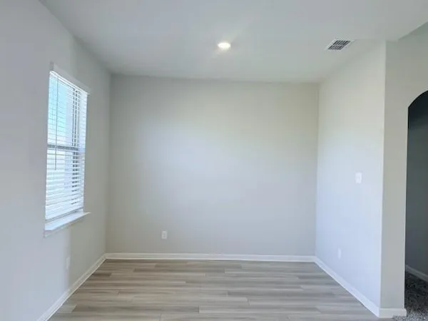 a view of room with window and hardwood floor