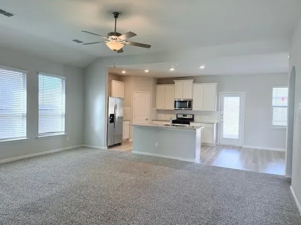 a view of kitchen with refrigerator and window