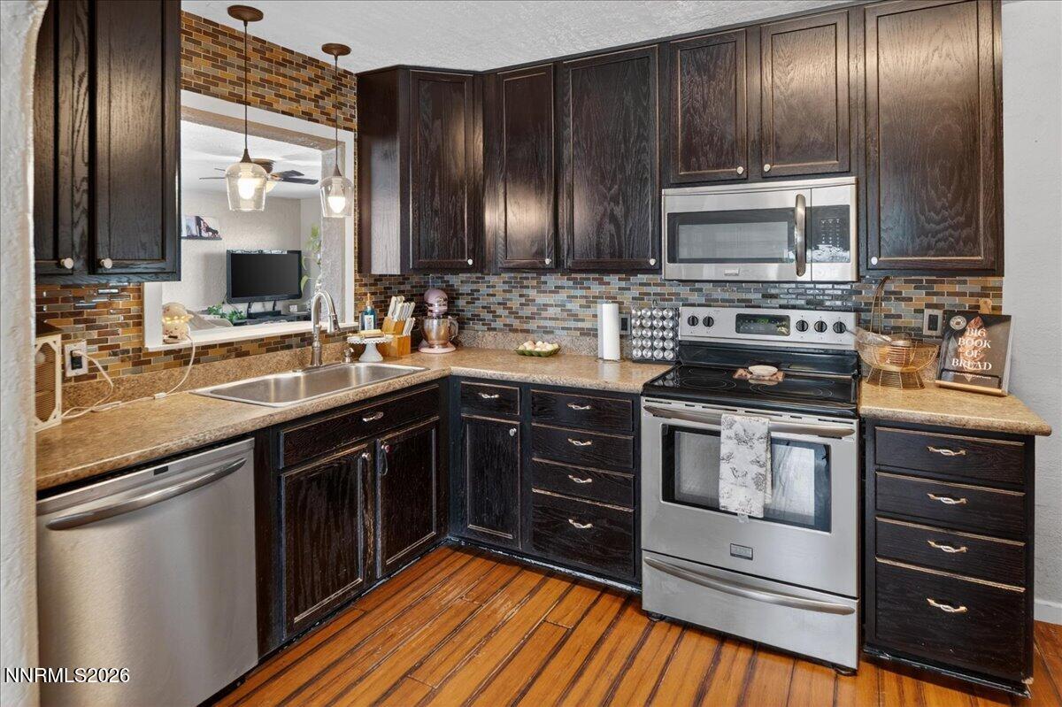 270 Vine Street Fernley, NV 89408 - Photo 19 of 28 a kitchen with stainless steel appliances wooden cabinets and stove