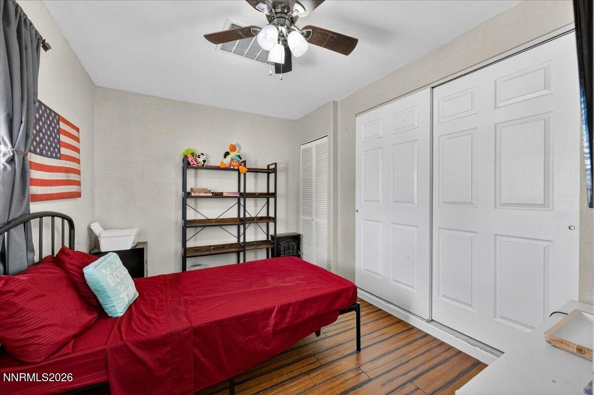 270 Vine Street Fernley, NV 89408 - Photo 22 of 28 a bedroom with a bed and a chandelier