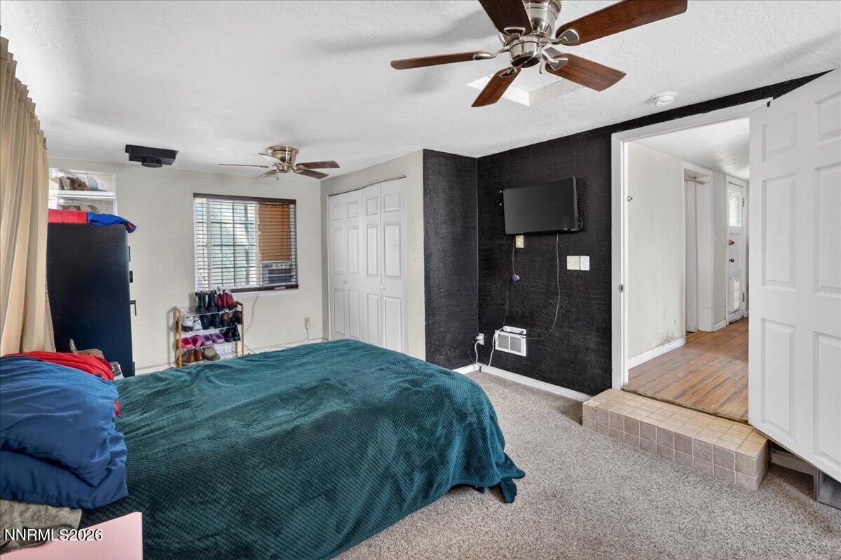 270 Vine Street Fernley, NV 89408 - Photo 25 of 28 a bedroom with a bed and a chandelier