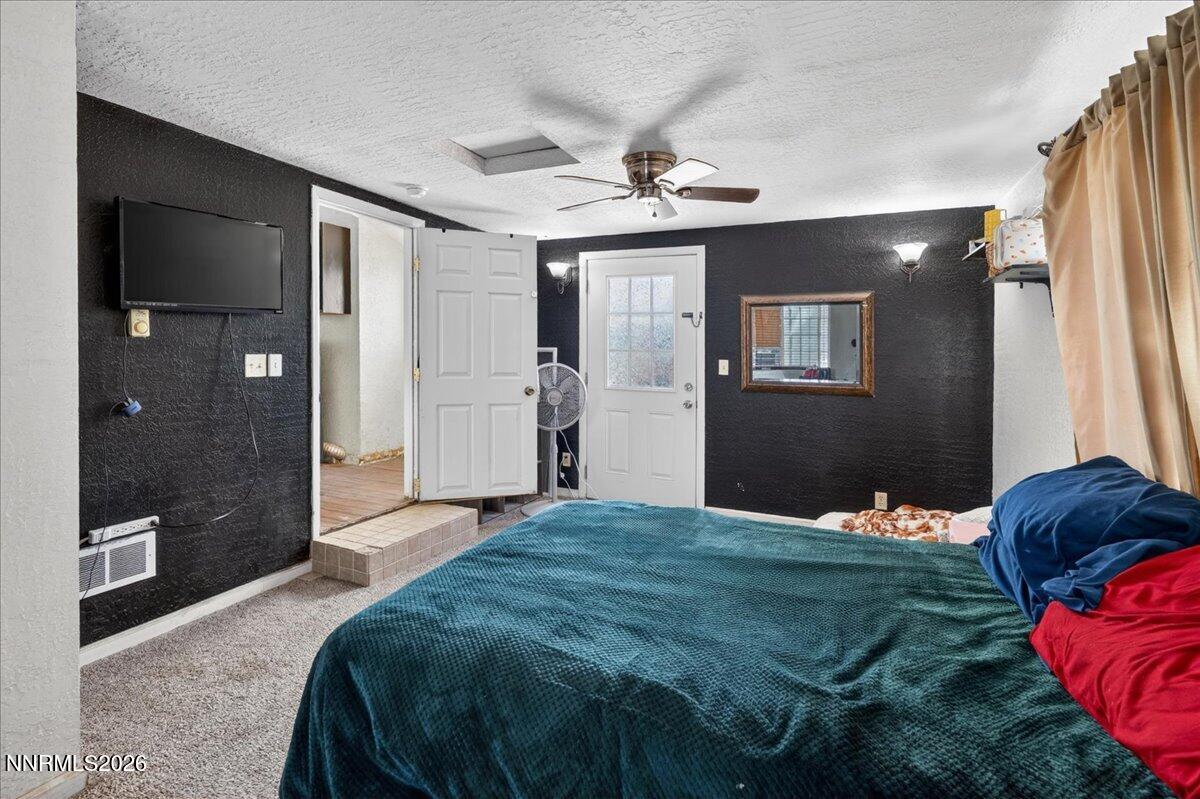 270 Vine Street Fernley, NV 89408 - Photo 26 of 28 a bedroom with a bed and a chandelier