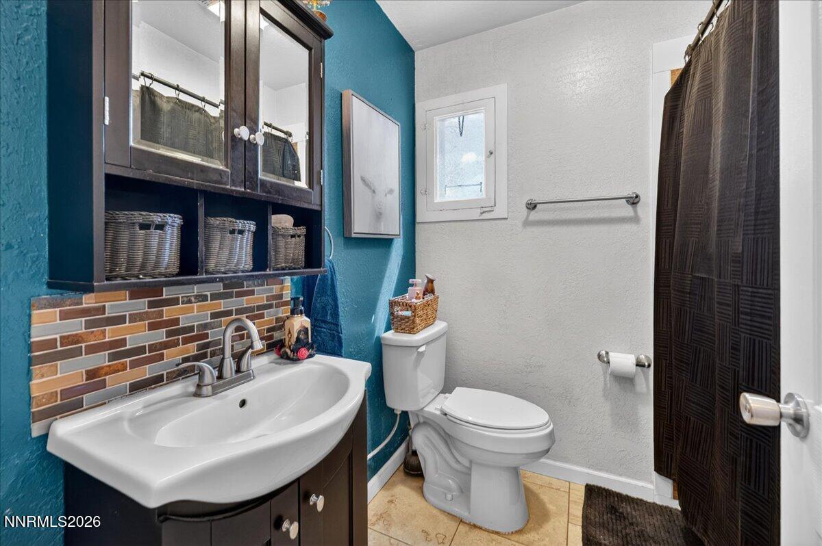 270 Vine Street Fernley, NV 89408 - Photo 27 of 28 a bathroom with a sink toilet and a mirror