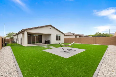 a front view of house with a garden and patio