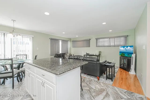a kitchen with center island table and chairs