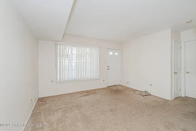 an empty room with a empty space and windows