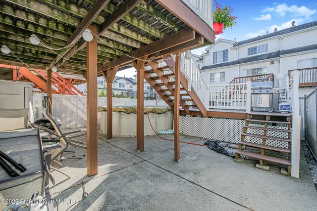 a balcony with chairs and a stove