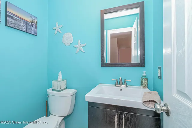 a bathroom with a toilet a sink and mirror