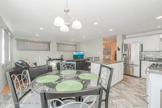 a dining room with furniture and a kitchen view
