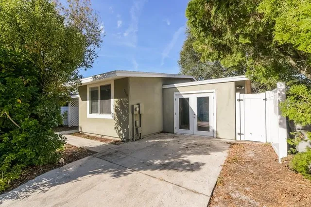 a front view of a house with a garden
